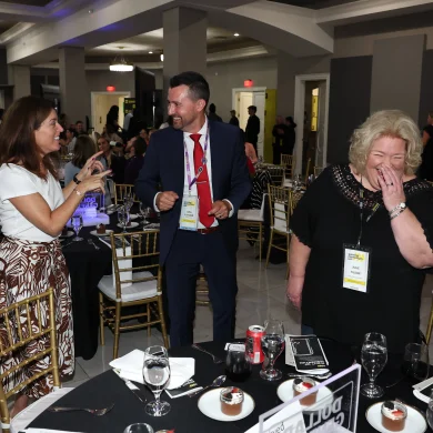 Josh Fletcher performing mentalism at a Dollar General mix and mingle event, audience members laughing in surprise